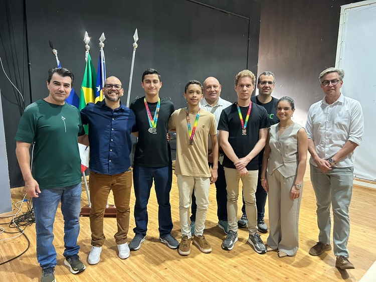 Mesa diretiva do evento posa para foto com os medalhistas do IFG